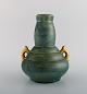 Josef Ekberg for Gustavsberg. Art deco vase with handles in glazed ceramics. 
Beautiful blue-green glaze and gold decoration. 1930s.
