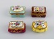 Limoges, France. Four small porcelain lidded chests with hand-painted flowers 
and gold decoration. Early 20th century.
