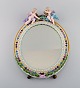 Antique Meissen porcelain mirror with original glass. Decorated with angels and 
repousse flowers. Approx. 1900.
