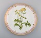 Dinner plate in Flora Danica style. Hand-painted flowers and gold decoration. 
Mid-20th century.
