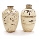 A pair of large cream glazed Citzhou Jars. China circa 1700-50. H: 68 & 73cm