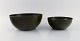 Kaj Franck (1911-1989) for Finel. Two dark green bowls in enamelled metal. 
Finnish design, mid 20th century.
