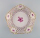 Herend bowl in openwork porcelain with hand-painted flowers and gold decoration. 
Mid 20th century. 
