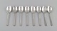 Eight Georg Jensen Pyramid dessert spoons in sterling silver.
