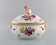 Royal Copenhagen Saxon Flower. Large soup tureen in hand-painted porcelain with 
flowers and gold decoration. Modeled with putti on top. Model number 4/1669. 
Early 20th century.
