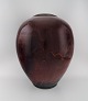 Maxence Jourdain. French contemporary ceramicist. Colossal unique floor vase in 
glazed stoneware. Beautiful ox blood running glaze. Dated 2004.
