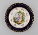 Antique Meissen plate in hand-painted porcelain. Romantic scene, blue border 
with gold decoration. Late 19th century.
