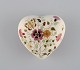 Heart-shaped Zsolnay lidded box in cream-colored porcelain with hand-painted 
flowers, butterflies and gold decoration. Late 20th century.

