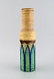 Italian studio ceramicist. Cylindrical vase in glazed stoneware. Hand painted 
green leaves on yellow background. 1960s / 70s.
