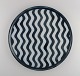 Aase Haugaard, Danish ceramicist. Large dish / wall decoration in glazed 
stoneware with wavy stripes. 1970s.
