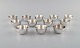 Elon Arenhill (1922-2018). Well-known Swedish silversmith. Twelve modernist cups 
in hammered sterling silver. Dated 1974.
