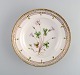 Royal Copenhagen Flora Danica deep plate in hand-painted porcelain with flowers 
and gold decoration. 
