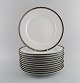 Sigvard Bernadotte for Christineholm. Twelve large dinner plates in porcelain 
with silver border. 1980s.
