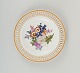 Antique Meissen openwork plate in hand-painted porcelain with flowers and gold 
decoration. Late 19th century.