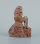 Figurine. Skovserkone with fish made of soapstone.