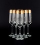 L'Art præsenterer: Italiensk design, seks champagneglas i klart kunstglas med guldkant.