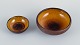 Osa, Denmark.
Two small retro unique ceramic bowls with glaze in yellow-brown tones.