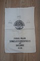 An old sack from Denmark
Text: "Statskontrolleret Vitaminiseret - Primol - 
Piller - 
Somælkstilskudsfoder til smågrise - 25 kg"
168cm x 46cm
In a good condition
We have a good selection of old sacks, with or 
without different texts