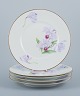 Royal Copenhagen, a set of five Art Nouveau plates hand-painted with lilies and 
gold trim.