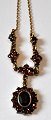 Gilded sterling 
necklace with 
garnets, 20th 
century.