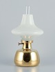 Henning Koppel for Louis Poulsen. Petronella oil lamp in brass with an opal 
glass shade.