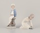 Lladro, Spain. Two porcelain figurines. Boy in sailor outfit with a model ship 
in hand and a girl figurine.