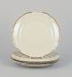 KPM, Poland. A set of four porcelain lunch plates.
Cream-colored with gold rim decoration.