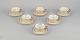 A set of six KP, Karlskrona tea cups with saucers in cream-colored porcelain 
with gold decoration.