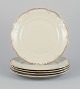 KPM, Poland. A set of five dinner plates in cream-colored porcelain.
Decorated with a gold rim.