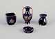 Limoges, France. Four pieces of porcelain miniatures, decorated with 22-karat 
gold leaf and a beautiful royal blue glaze. Scène galante.