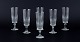 A set of six Swedish Champagne flutes in clear glass. Faceted.