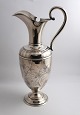 Lundin Antique 
præsenterer: 
I. Holm, 
København. 
Sølvkande 
(830). Højde 
32,5 cm. Med 
Grevekrone 
indgraveret ...