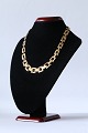 Block gold necklace in 14 carat gold with 3 rows in sequence, and box lock. Stamped GIFA 585.SOLD