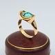 Hans Hansen; A 
ring of 14k 
gold with 
turquoise