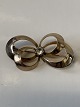 8 Karat guld, 
broche med klar 
sten
Måler 3,6 x 
1,9 cm.