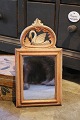 Swedish 19th century, small mirror in wood with a fine carved swan on top...