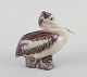 L'Art 
præsenterer: 

Jeanne 
Grut for Royal 
Copenhagen, 
pelikanfigur af 
keramik.