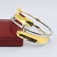 Ole Bent Petersen; A Danish designed bangle of 18k gold and steel