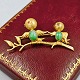 Brooch with 
birds in 14k 
gold set with 
jade and ruby