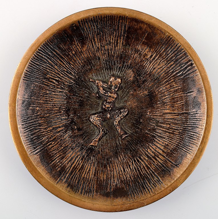 Bronze dish depicting a pan-playing faun.
