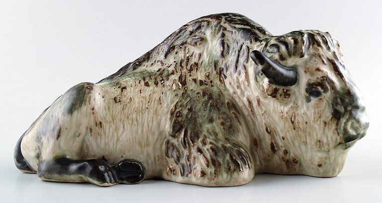 Royal Copenhagen stoneware figurine no. 22604, lying bison.
