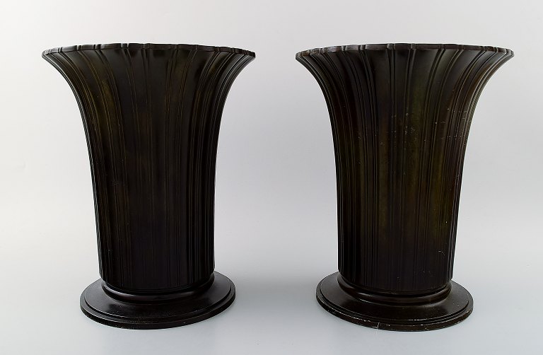 Just Andersen: b. Godhavn, Greenland 1884, d. Glostrup 1943.  
A pair of vases of patinated disco metal, casted with vertical fluted pattern.