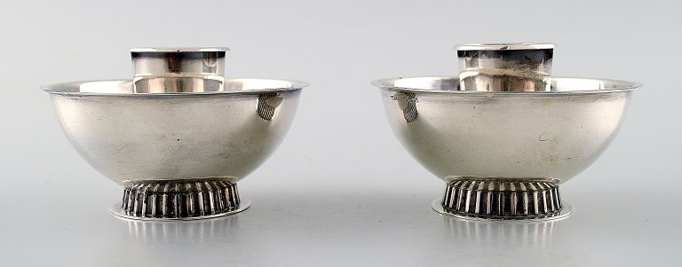 K & EC, Gothenburg, a pair of low Swedish Art Deco silver candlesticks.