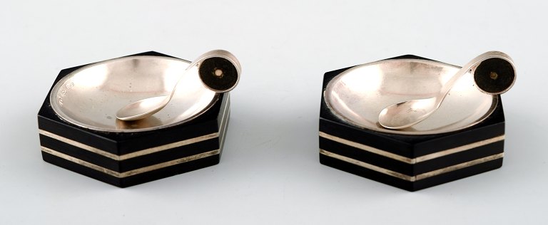 GAB (Guldsmedsaktiebolaget) a pair of art deco hexagonal salt cellar in silver 
and ebony with matching salt spoons.
Sweden, 1936.