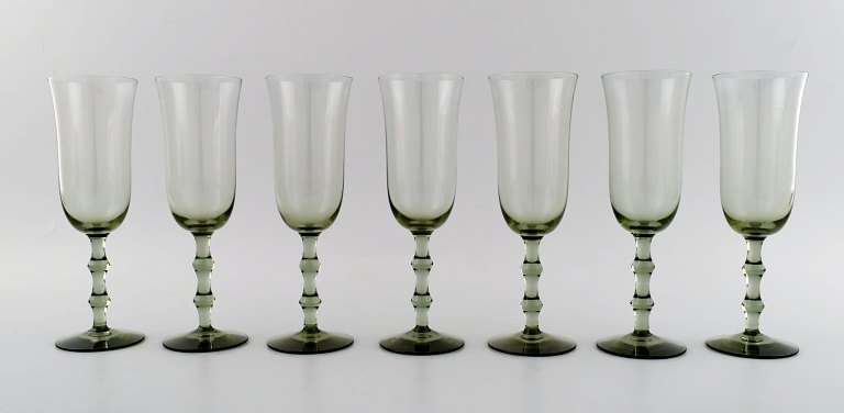 SIMON GATE FOR ORREFORS, A set of seven smoky champagne art glasses.