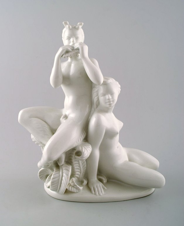 Harald Salomon for Rörstrand, white glazed porcelain Art Deco figure of a naked 
woman and flute-playing pan.