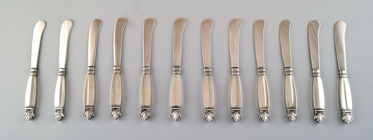 Tolv tidlige Georg Jensen Dronning Sølv, smørknive i helsølv.