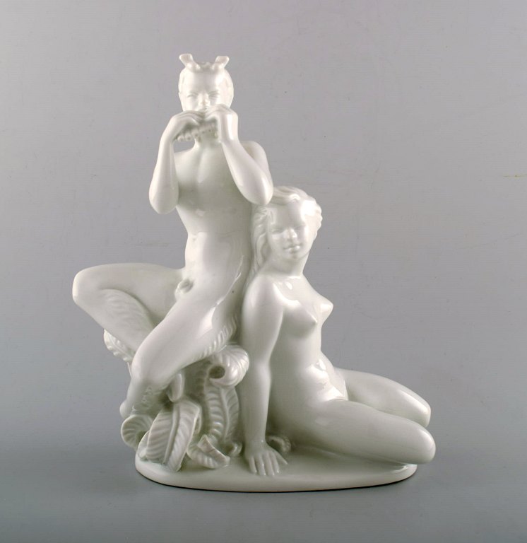 Harald Salomon for Rörstrand, white glazed porcelain Art Deco figure of a naked 
woman and flute-playing pan.