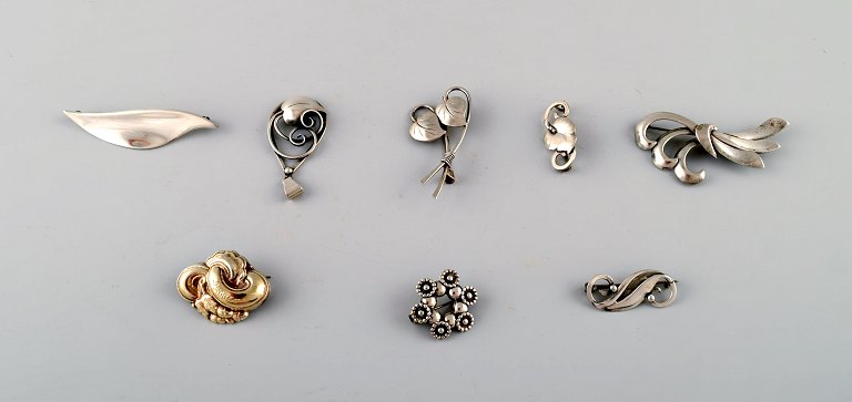 Seven danish brooches in silver and an pendant.
