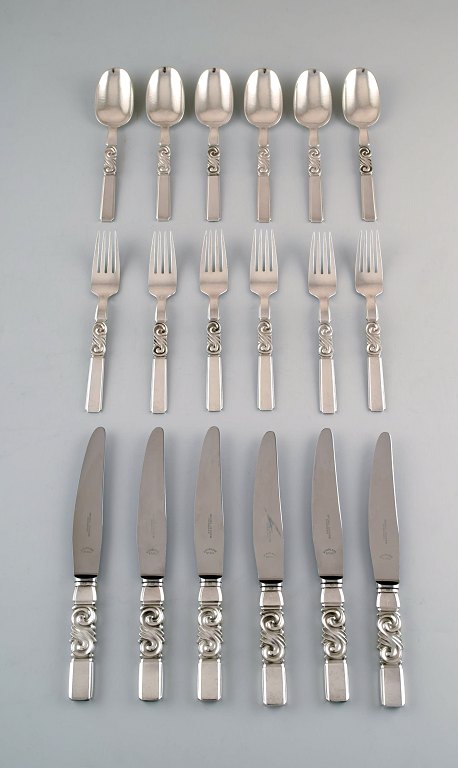 Georg Jensen. Cutlery, Scroll No. 22, Complete dinner service of hammered 
sterling silver.